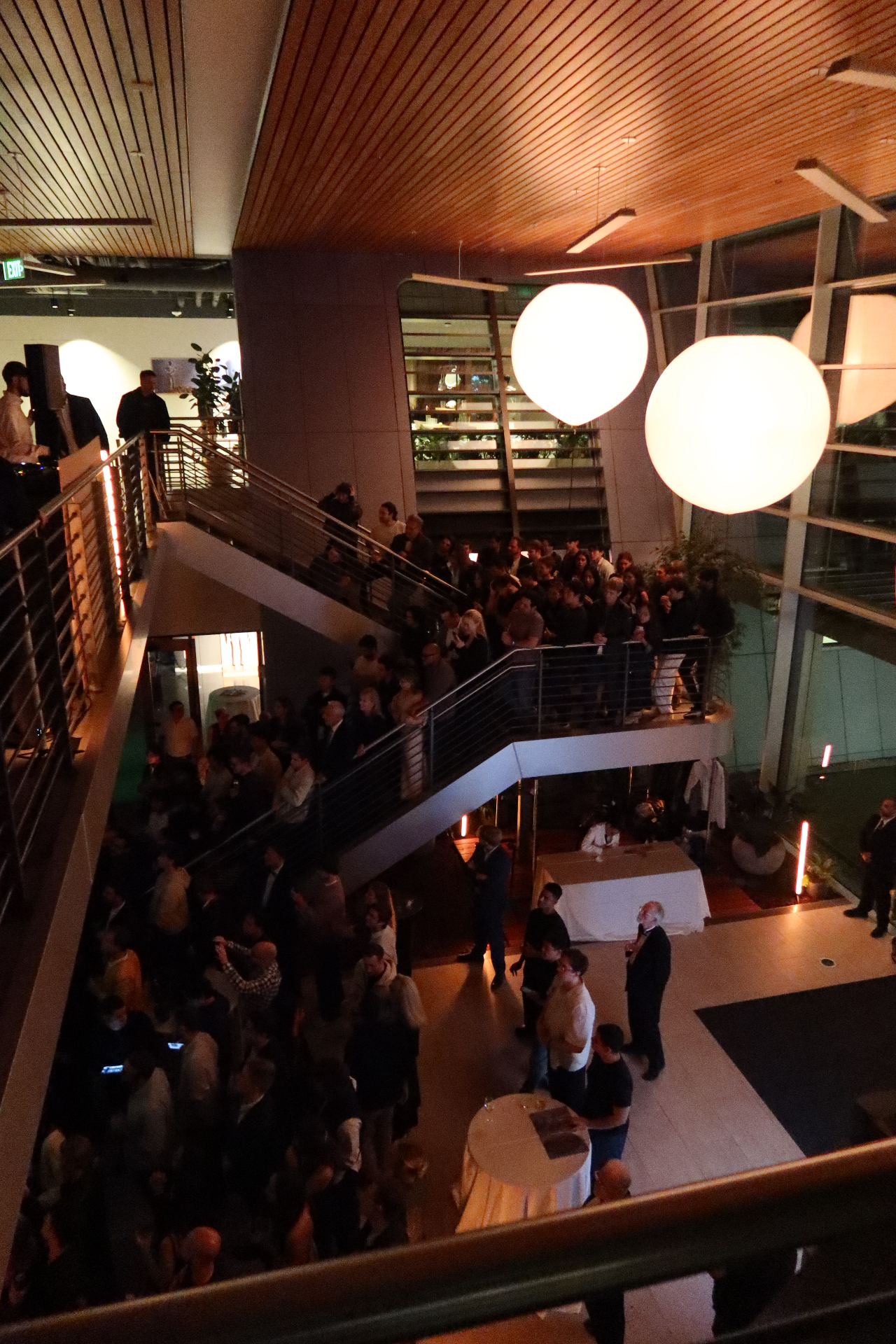 Corporate atrium event with crowd and lighting