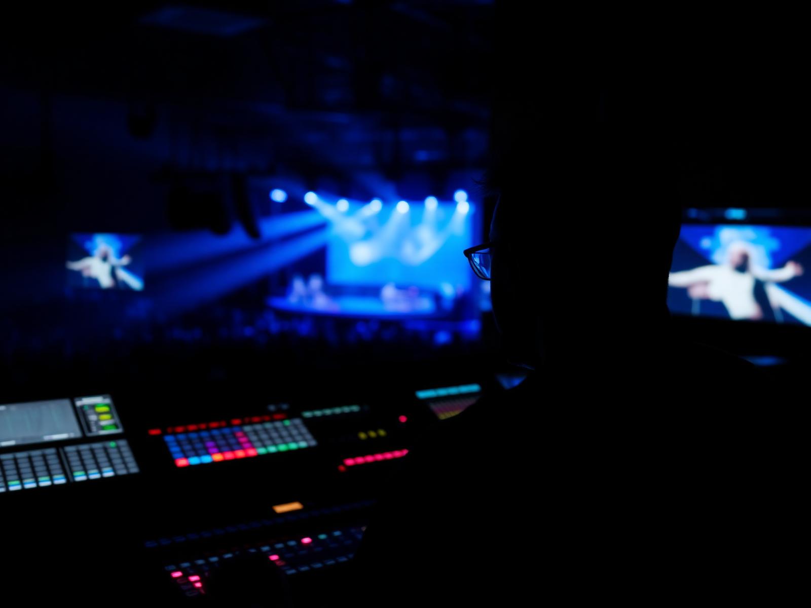 Audio engineer at a lighting console during a live event
